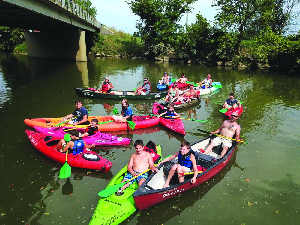 Fun in the river with kids under bridge at Happy Paddles in Spencerville