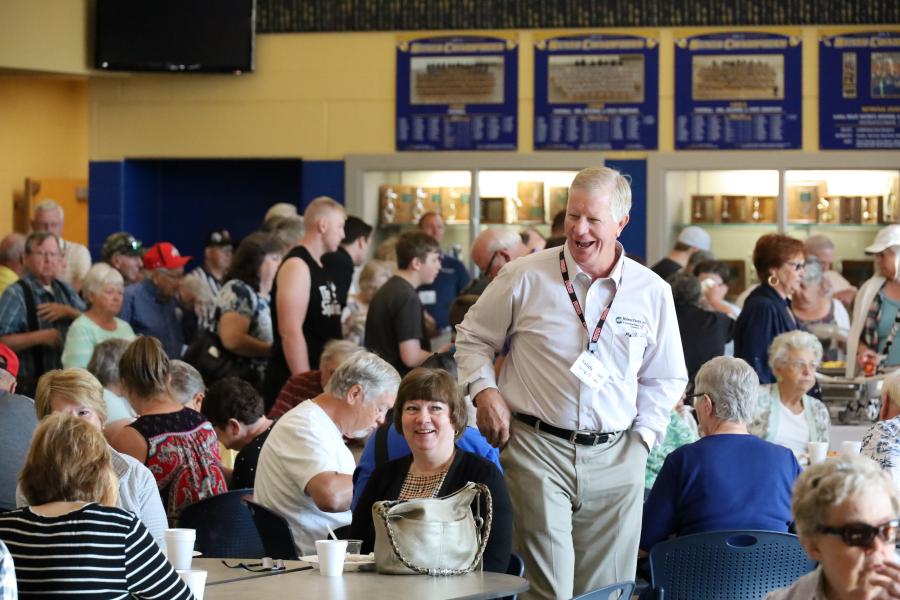 Board director chats with members during breakfast